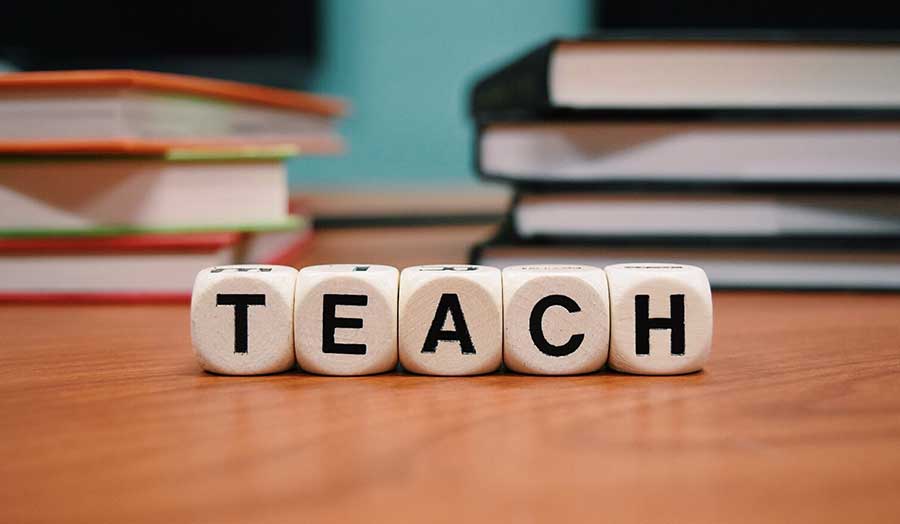 Letter blocks spelling teach
